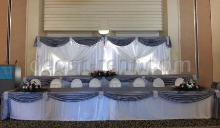 EVENT BACKDROP IN WHITE AND SILVER WITH RHINESTONE ACCENTS.